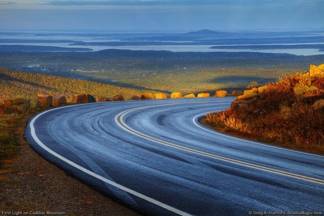 a highway with a mountain in the background