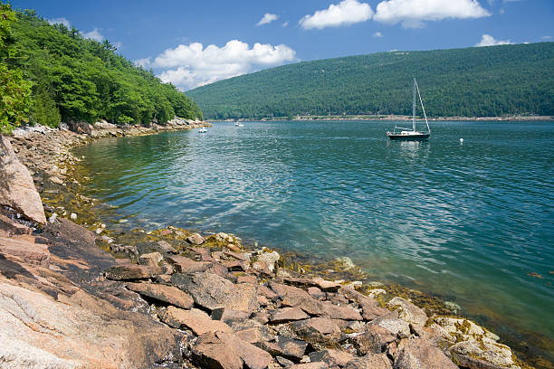 a rocky island in the middle of a body of water