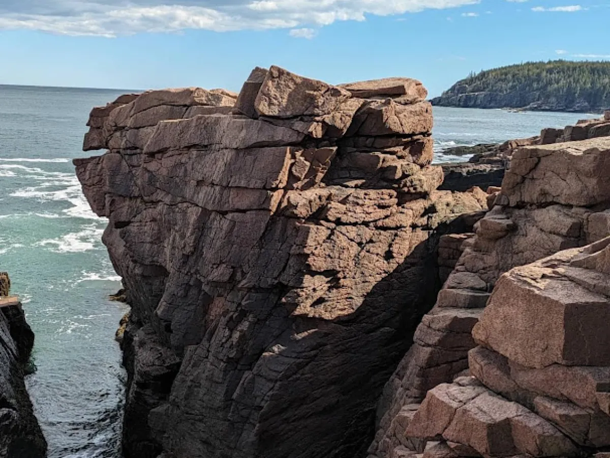 a rocky island in the middle of a body of water