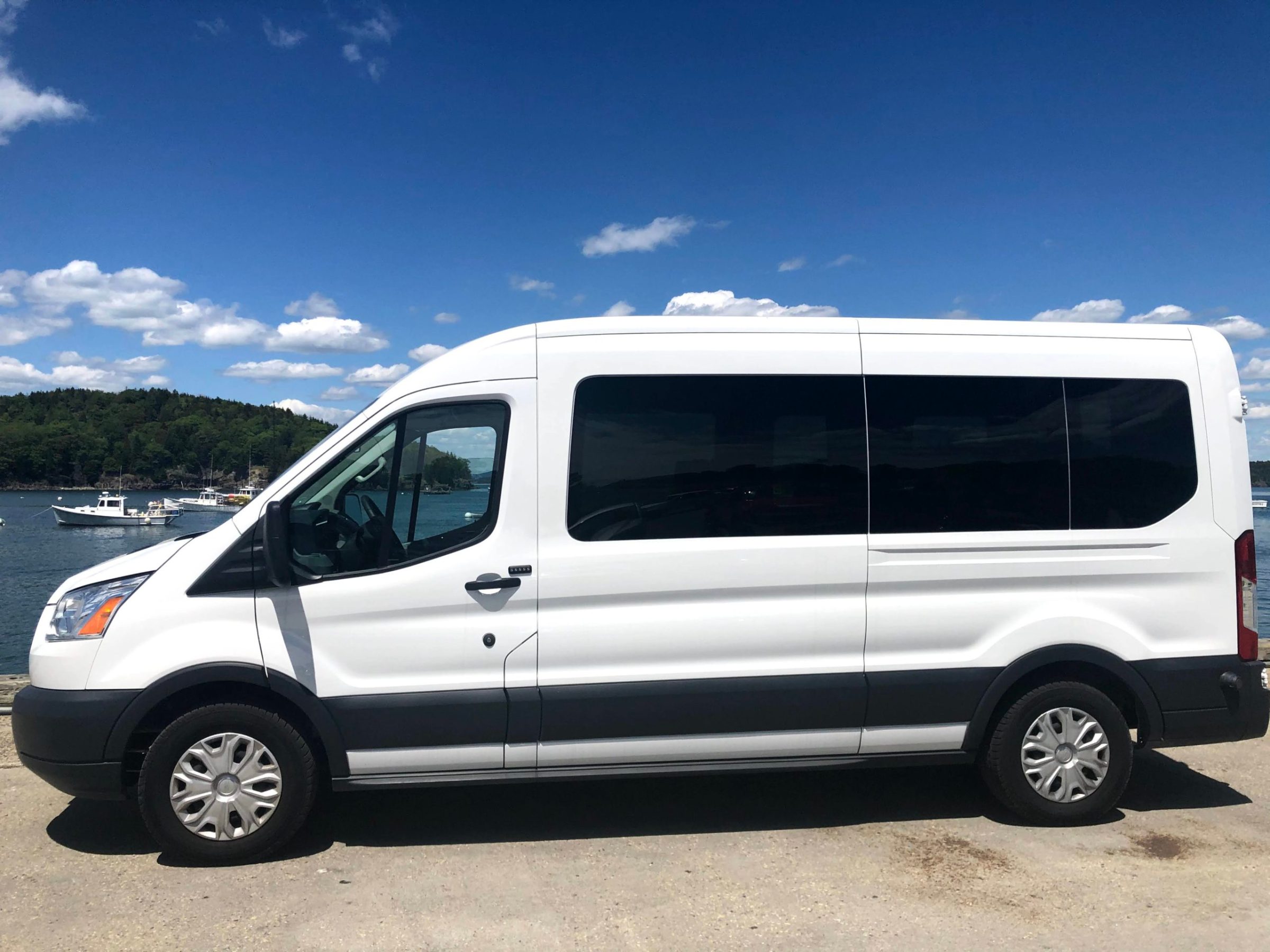 a white van parked in front of a car