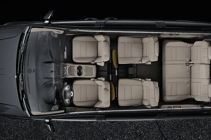 a toaster oven sitting on top of a suitcase