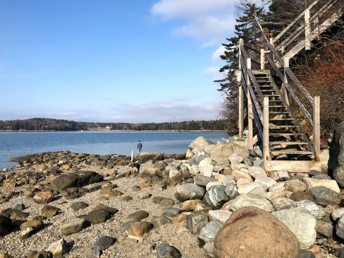 a rocky island in the middle of a body of water
