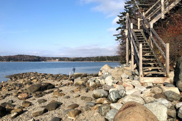 a rocky island in the middle of a body of water