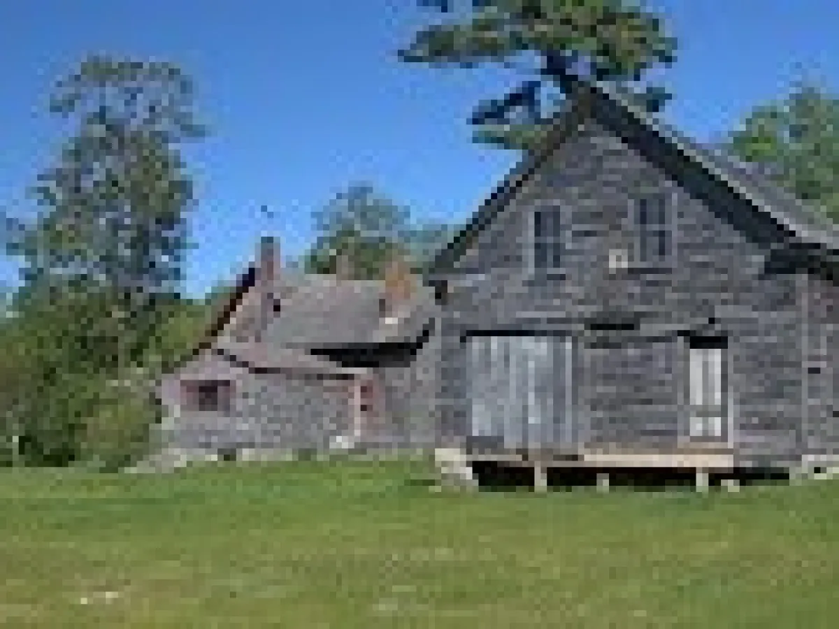 an old barn in a field