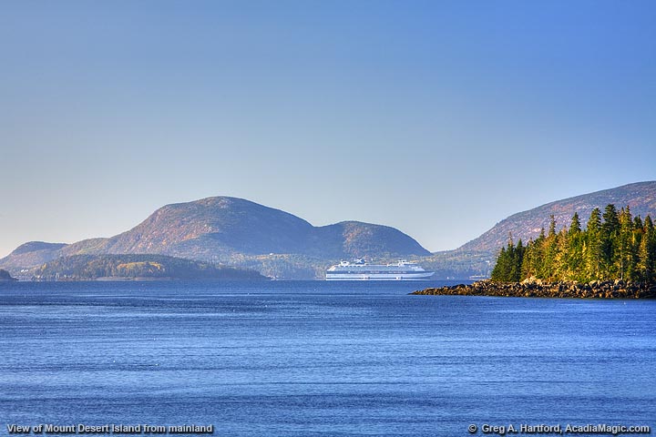 a body of water with a mountain in the background