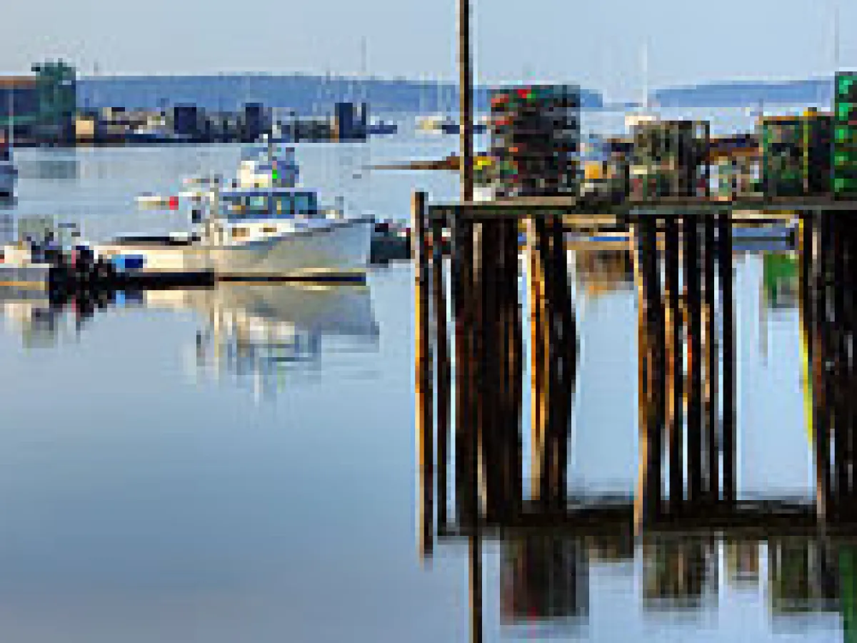 a boat is docked next to a body of water