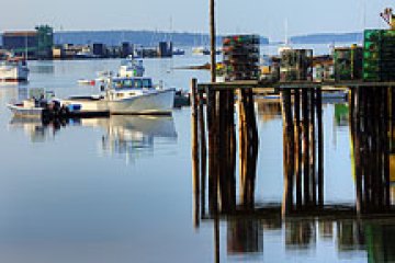 a boat is docked next to a body of water