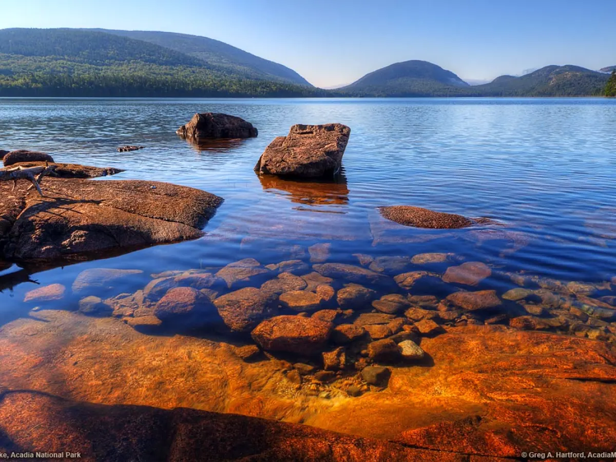a body of water with a mountain in the background