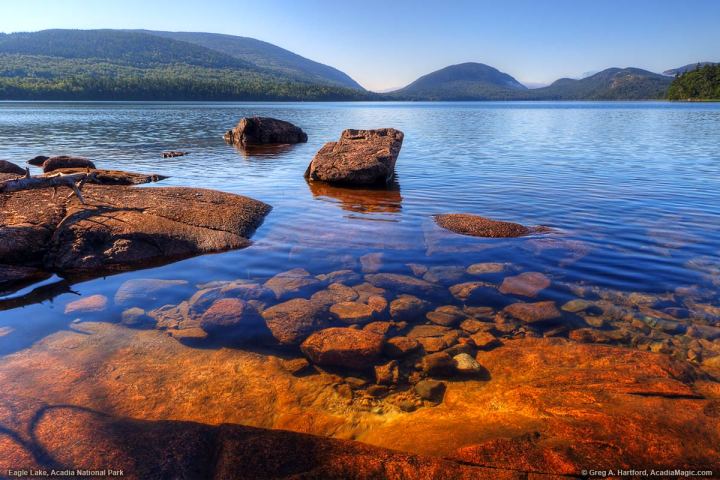 a body of water with a mountain in the background